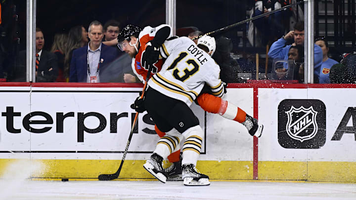 Jan 27, 2024; Philadelphia, Pennsylvania, USA; Boston Bruins center Charlie Coyle (13) hits Philadelphia Flyers defenseman Rasmus Ristolainen (55) in the first period at Wells Fargo Center. Mandatory Credit: Kyle Ross-Imagn Images