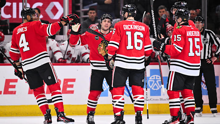Apr 14, 2024; Chicago, Illinois, USA; Chicago Blackhawks forward Frank Nazar (91) celebrates with teammates defenseman Seth Jones (4), forward Jason Dickinson (16) and forward Joey Anderson (15) after scoring his first NHL goal in his NHL debut in the first period against the Carolina Hurricanes at United Center. Mandatory Credit: Jamie Sabau-USA TODAY Sports