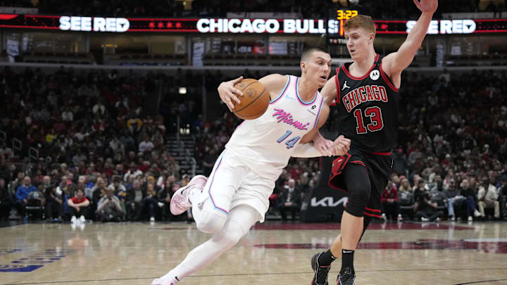 Apr 9, 2025; Chicago, Illinois, USA; Chicago Bulls guard Kevin Huerter (13) defends Miami Heat guard Tyler Herro (14) during the second half at United Center. Mandatory Credit: David Banks-Imagn Images