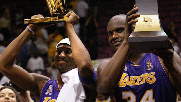June 12, 2002; East Rutherford, NJ; The Lakers Kobe Bryant holds up the Championship trophy along with teammate Shaquille O'Neal who holds up his third MVP trophy. Mandatory Credit:  Michael J. Terola/Abury Park Press-USA TODAY NETWORK 