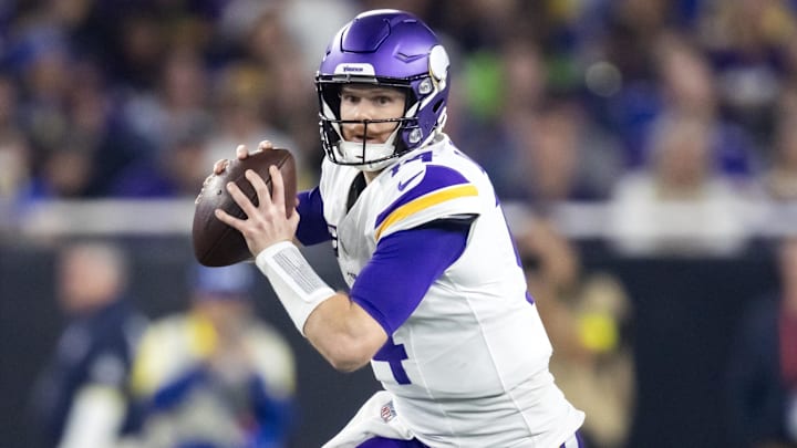 Jan 13, 2025; Glendale, AZ, USA; Minnesota Vikings quarterback Sam Darnold (14) against the Los Angeles Rams during an NFC wild card game at State Farm Stadium. Mandatory Credit: Mark J. Rebilas-Imagn Images