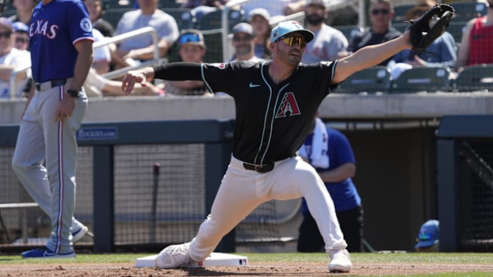 Arizona Diamondbacks first baseman Trey Mancini stretches for a throw against the Texas Rangers during Cactus League play at Salt River Fields on March 9, 2025.