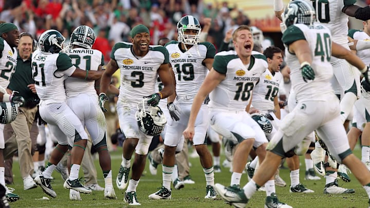January 2, 2012; Tampa, FL, USA; Michigan State Spartans wide receiver B.J. Cunningham (3) and teammates celebrate after they defeated the Georgia Bulldogs of the 2012 Outback Bowl at Raymond James Stadium. Michigan State Spartans defeated the Georgia Bulldogs 33-30 in triple overtime. Mandatory Credit: Kim Klement-Imagn Images