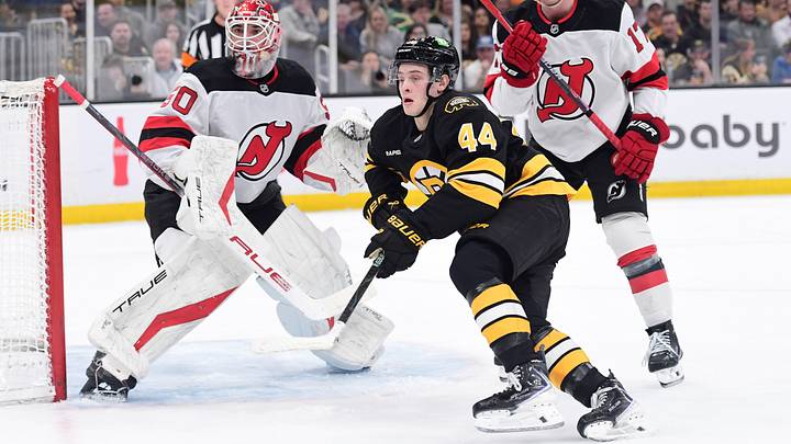 Apr 14, 2026; Boston, Massachusetts, USA; New Jersey Devils goalie Nico Daws (50) looks on as defenseman Simon Nemec (17) and Boston Bruins forward James hagen (44) go after the puck during the first period at TD Garden. Mandatory Credit: Bob DeChiara-Imagn Images