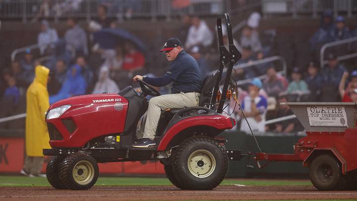 Atlanta, Georgia, USA; An Atlanta Braves grounds crew member works on the field during a delay against the San Francisco Giants in the second inning at Truist Park. Mandatory Credit: Brett Davis-Imagn Images