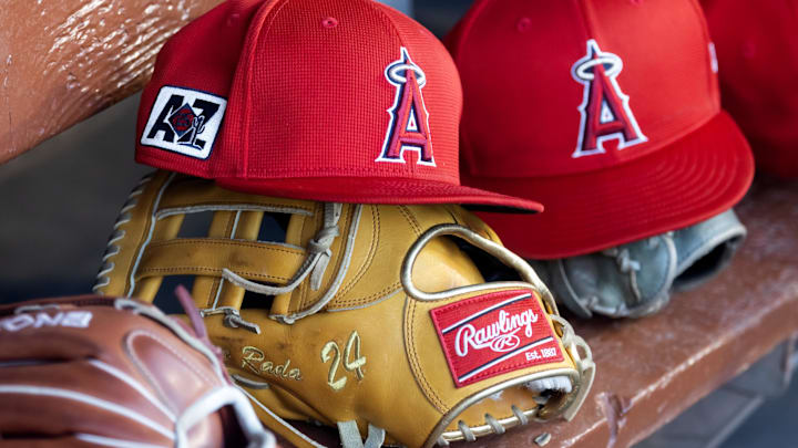 Feb 28, 2025; Phoenix, Arizona, USA; Detailed view of the Los Angeles Angels logo on a hat in the dugout during a spring training game at Camelback Ranch-Glendale. Mandatory Credit: Mark J. Rebilas-Imagn Images
