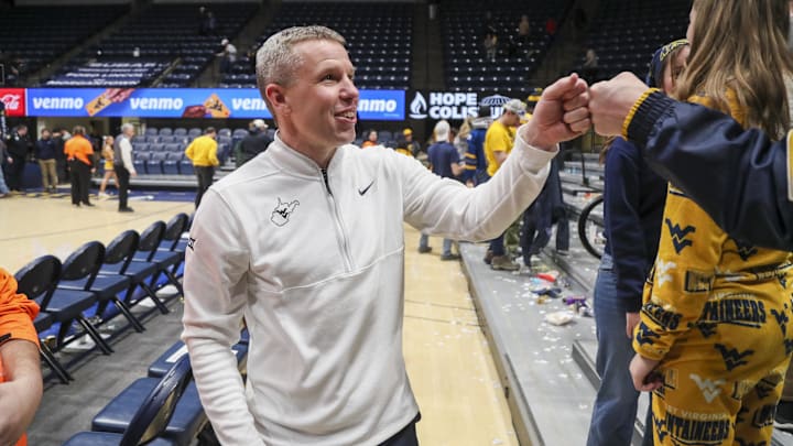 Jan 27, 2026; Morgantown, West Virginia, USA; West Virginia Mountaineers head coach Ross Hodge celebrates with fans after defeating the Kansas State Wildcats at Hope Coliseum. Mandatory 