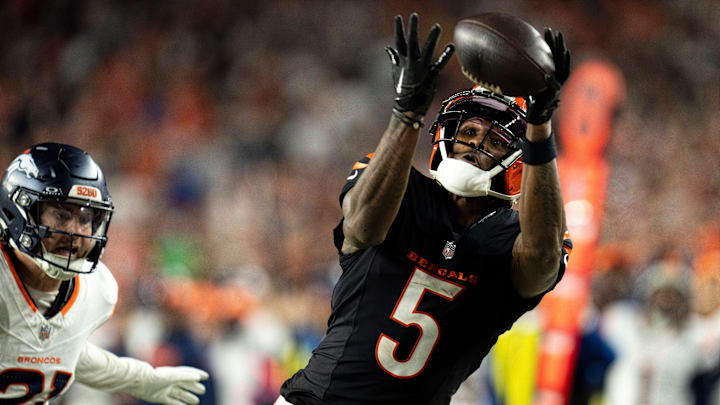 Cincinnati Bengals wide receiver Tee Higgins (5) catches a pass inside the 5-yard line as Denver Broncos cornerback Riley Moss (21) defends in overtime of the NFL game at Paycor Stadium in Cincinnati on Saturday, Dec. 28, 2024. Cincinnati Bengals wide receiver Tee Higgins (5) catches a pass inside the 5-yard line as Denver Broncos cornerback Riley Moss (21) defends in overtime of the NFL game at Paycor Stadium in Cincinnati on Saturday, Dec. 28, 2024.