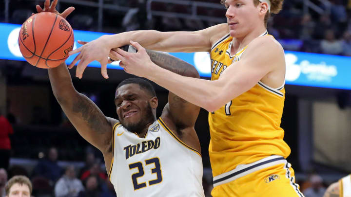 Kent State Golden Flashes forward Magnus Entenmann (14) and Toledo Rockets guard Tyler Cochran (23) fight for a rebound during the second half of an NCAA college basketball game in the quarterfinals of the Mid-American Conference Tournament at Rocket Mortgage FieldHouse, Thursday, March 14, 2024, in Cleveland, Ohio. Kent State Golden Flashes forward Magnus Entenmann (14) and Toledo Rockets guard Tyler Cochran (23) fight for a rebound during the second half of an NCAA college basketball game in the quarterfinals of the Mid-American Conference Tournament at Rocket Mortgage FieldHouse, Thursday, March 14, 2024, in Cleveland, Ohio.
