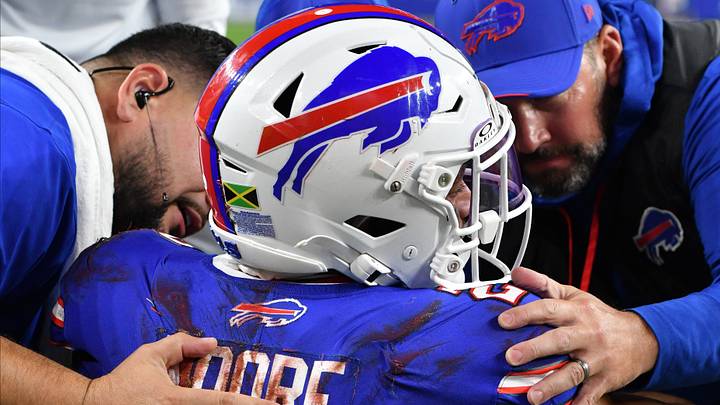 Sep 17, 2026; Orchard Park, New York, USA; Trainers attend to Buffalo Bills wide receiver DJ Moore (2) after an apparent injury during the first half against the Detroit Lions at New Highmark Stadium. Sep 17, 2026; Orchard Park, New York, USA; Trainers attend to Buffalo Bills wide receiver DJ Moore (2) after an apparent injury during the first half against the Detroit Lions at New Highmark Stadium.