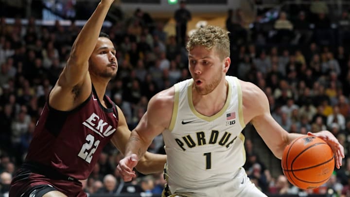 Eastern Kentucky Colonels guard Pierce Thomas (22) defends Purdue Boilermakers forward Caleb Furst (1)