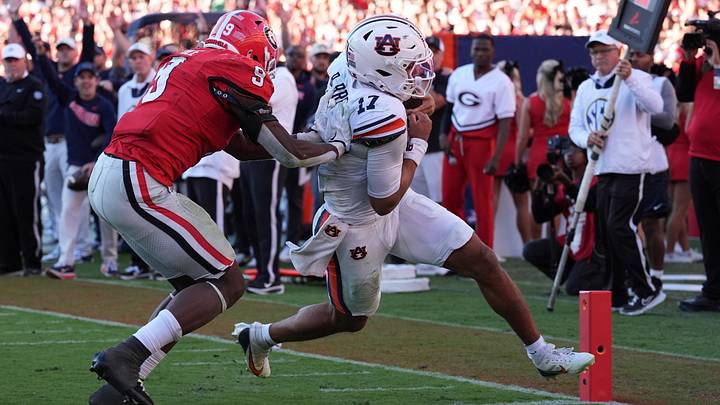 Oct 17, 2026; Athens, Georgia, USA;  Auburn quarterback Byrum Brown (17) runs for a touchdown past Georgia linebacker Chris Cole (9) during the third quarter at Sanford Stadium.  Mandatory Credit: Dale Zanine-Imagn Images
