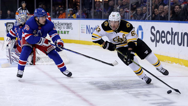 Feb 5, 2025; New York, New York, USA; Boston Bruins left wing Brad Marchand (63) controls the puck against New York Rangers defenseman Ryan Lindgren (55) during the first period at Madison Square Garden. Mandatory Credit: Brad Penner-Imagn Images