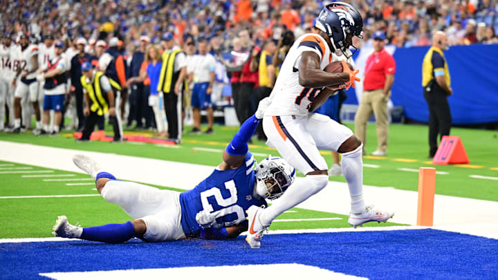Aug 11, 2024; Indianapolis, Indiana, USA; Denver Broncos wide receiver Marvin Mims Jr. (19) scores a touchdown against Indianapolis Colts safety Nick Cross (20) during the second quarter  at Lucas Oil Stadium. 