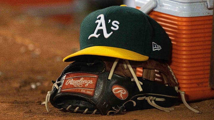 Jul 17, 2023; Oakland, California, USA;  General view of the Oakland Athletics cap and glove during the seventh inning against the Boston Red Sox at Oakland-Alameda County Coliseum. Mandatory Credit: Stan Szeto-Imagn Images