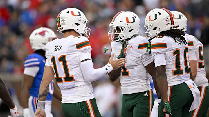 Nov 1, 2025; Dallas, Texas, USA;  Miami Hurricanes wide receiver Joshisa Trader (1) and quarterback Carson Beck (11) celebrates a touchdown against the SMU Mustangs during the first quarter at Gerald J. Ford Stadium. Mandatory Credit: Jerome Miron-Imagn Images