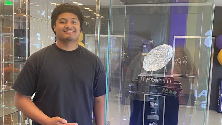 Esun Tafa, recruit from Utah, checks out the UW trophy case on a summer visit. 