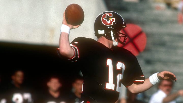 Jim Kelly of the Houston Gamblers drops back to pass against the Tampa Bay Bandits during a 1985 USFL football game.