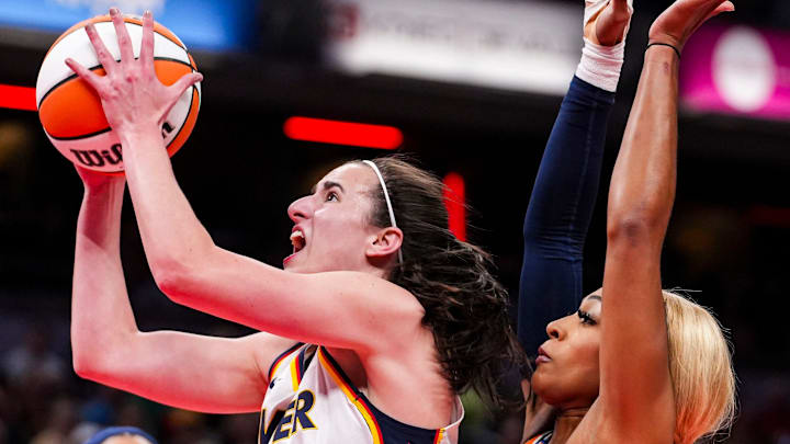 Indiana Fever guard Caitlin Clark (22) goes up for a shot against Connecticut Sun guard DiJonai Carrington (21) on Wednesday, Aug. 28, 2024, during a game between the Indiana Fever and the Connecticut Sun at Gainbridge Fieldhouse in Indianapolis.