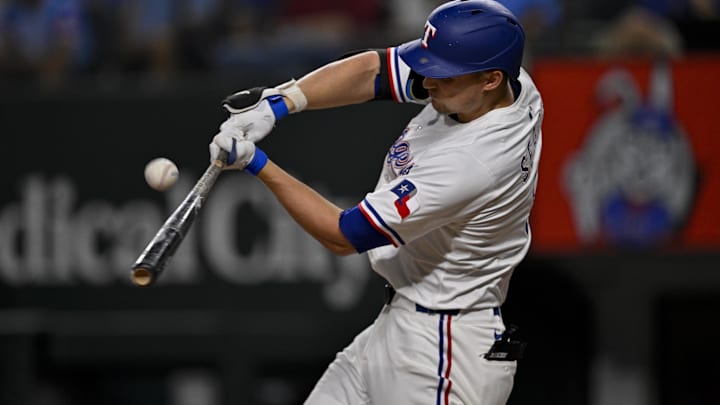 Aug 11, 2025; Arlington, Texas, USA; Texas Rangers shortstop Corey Seager (5) bats during the game between the Texas Rangers and the Arizona Diamondbacks at Globe Life Field.