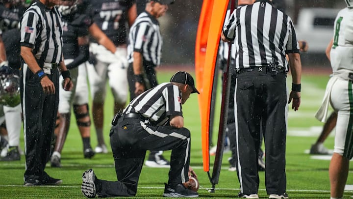 The referees measure the ball to see if Alcoa made a first down during a TSSAA football between between Greeneville and Alcoa High School on Thursday, September 12, 2024. Alcoa won 31-13 against Greeneville.