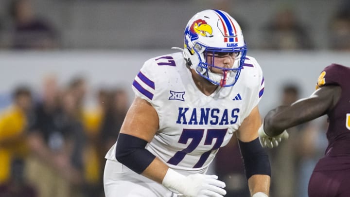 Oct 5, 2024; Tempe, Arizona, USA; Kansas Jayhawks offensive lineman Bryce Cabeldue (77) against the Arizona State Sun Devils at Mountain America Stadium. Mandatory Credit: Mark J. Rebilas-Imagn Images