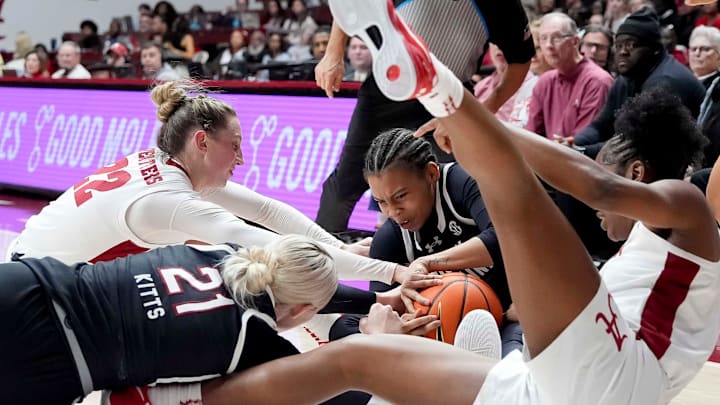 South Carolina forward Chloe Kitts (21), South Carolina guard Maddy McDaniel (1), Alabama guard Karly Weathers (22), and Alabama guard Zaay Green (14) try to control a ball on the floor Thursday, Jan. 16, 2025, at Coleman Coliseum in Tuscaloosa, Alabama. South Carolina forward Chloe Kitts (21), South Carolina guard Maddy McDaniel (1), Alabama guard Karly Weathers (22), and Alabama guard Zaay Green (14) try to control a ball on the floor Thursday, Jan. 16, 2025, at Coleman Coliseum in Tuscaloosa, Alabama.