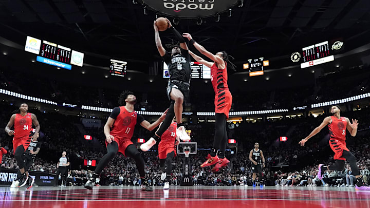 Apr 6, 2025; Portland, Oregon, USA: San Antonio Spurs guard Stephon Castle (5) lays up a shot against Portland Trail Blazers guard Dalano Banton (5, right) during the first half at Moda Center. Mandatory Credit: Soobum Im-Imagn Images Apr 6, 2025; Portland, Oregon, USA: San Antonio Spurs guard Stephon Castle (5) lays up a shot against Portland Trail Blazers guard Dalano Banton (5, right) during the first half at Moda Center. Mandatory Credit: Soobum Im-Imagn Images