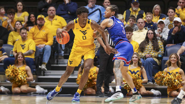 Jan 10, 2026; Morgantown, West Virginia, USA; West Virginia Mountaineers forward Brenen Lorient (0) backs down against Kansas Jayhawks guard Tre White (3) during the first half at Hope Coliseum. Mandatory Credit: Ben Queen-Imagn Images