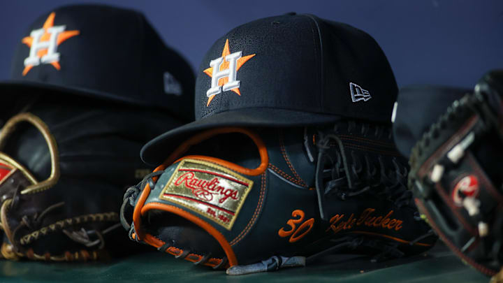 Apr 21, 2023; Atlanta, Georgia, USA; A detailed view of a Houston Astros hat and glove in the dugout against the Atlanta Braves in the fifth inning at Truist Park. Apr 21, 2023; Atlanta, Georgia, USA; A detailed view of a Houston Astros hat and glove in the dugout against the Atlanta Braves in the fifth inning at Truist Park.