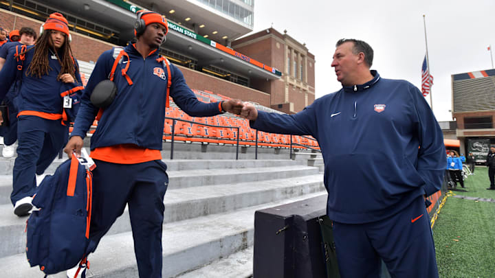 Nov 16, 2024; Champaign, Illinois, USA; Illinois Fighting Illini head coach Bret Bielema gives a hand to players before the game against the Michigan State Spartans at Memorial Stadium.