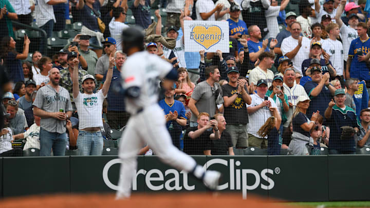 Aug 5, 2025; Seattle, Washington, USA; A fan holds up a sign after as Seattle Mariners third baseman Eugenio Suarez (28) runs the bases after hitting a 2-run home run against the Chicago White Sox during the fourth inning at T-Mobile Park. Mandatory Credit: Steven Bisig-Imagn Images
