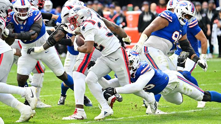 Oct 4, 2026; Orchard Park, New York, USA;  New England Patriots running back Treveyon Henderson (32) rushes as Buffalo Bills linebacker Greg Rousseau (15) tackles during the third quarter at New Highmark Stadium.  Mandatory Credit: Mark Konezny-Imagn Images