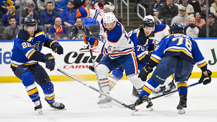 Feb 4, 2025; St. Louis, Missouri, USA;  Edmonton Oilers center Jeff Skinner (53) battles for the puck against St. Louis Blues defenseman Ryan Suter (22) and center Zack Bolduc (76) during the first period at Enterprise Center. Mandatory Credit: Jeff Curry-Imagn Images