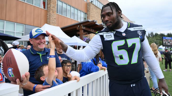 Seattle Seahawks offensive tackle Charles Cross (67) interacts with fans after the first training camp at Virginia Mason Athletic Center. Seattle Seahawks offensive tackle Charles Cross (67) interacts with fans after the first training camp at Virginia Mason Athletic Center.