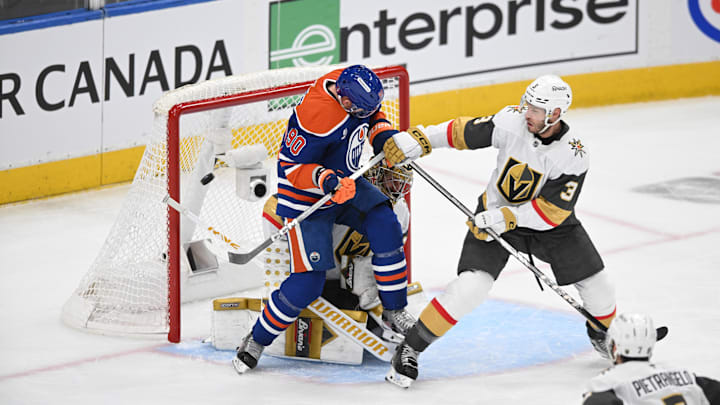 Edmonton Oilers right winger Corey Perry (90) battles with Vegas Golden Knights defenceman Brayden McNabb (3)