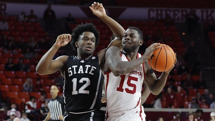 Feb 22, 2025; Norman, Oklahoma, USA; Oklahoma Sooners guard Duke Miles (15) drives to the basket beside Mississippi State Bulldogs guard Josh Hubbard (12) during the second half at Lloyd Noble Center. Mandatory Credit: Alonzo Adams-Imagn Images
