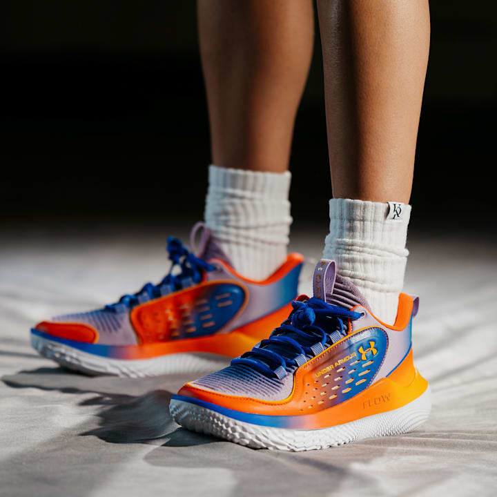 Kelsey Plum models Under Armour shoes.