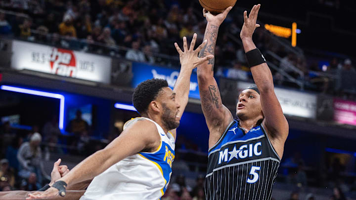 Dec 31, 2025; Indianapolis, Indiana, USA; Orlando Magic forward Paolo Banchero (5) shoots the ball while Indiana Pacers center/forward Tony Bradley (13) defends in the second half at Gainbridge Fieldhouse. Mandatory Credit: Trevor Ruszkowski-Imagn Images Dec 31, 2025; Indianapolis, Indiana, USA; Orlando Magic forward Paolo Banchero (5) shoots the ball while Indiana Pacers center/forward Tony Bradley (13) defends in the second half at Gainbridge Fieldhouse. Mandatory Credit: Trevor Ruszkowski-Imagn Images
