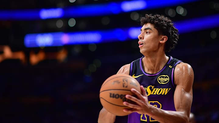 Dec 23, 2024; Los Angeles, California, USA; Los Angeles Lakers guard Max Christie (12) controls the ball against the Detroit Pistons during the second half at Crypto.com Arena. Mandatory Credit: Gary A. Vasquez-Imagn Images