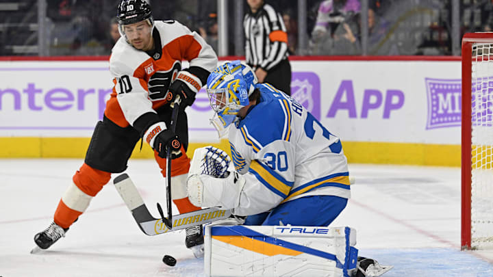 Nov 20, 2025; Philadelphia, Pennsylvania, USA; Philadelphia Flyers right wing Bobby Brink (10) reaches for the puck as St. Louis Blues goaltender Joel Hofer (30) makes a save during the first period at Xfinity Mobile Arena. Mandatory Credit: Eric Hartline-Imagn Images