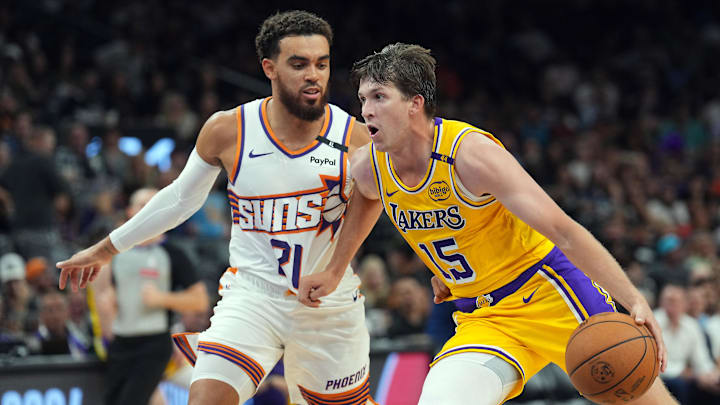 Oct 17, 2024; Phoenix, Arizona, USA; Los Angeles Lakers guard Austin Reaves (15) dribbles against Phoenix Suns guard Tyus Jones (21) during the second half at Footprint Center. Mandatory Credit: Joe Camporeale-Imagn Images