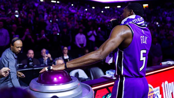 Jan 22, 2025; Sacramento, California, USA; Sacramento Kings guard De'Aaron Fox (5) lights the beam in celebration of their victory against the Golden State Warriors at Golden 1 Center.
