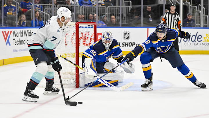 Feb 25, 2025; St. Louis, Missouri, USA;  St. Louis Blues goaltender Jordan Binnington (50) and defenseman Philip Broberg (6) defend the net against Seattle Kraken right wing Jordan Eberle (7) during the third period at Enterprise Center. Mandatory Credit: Jeff Curry-Imagn Images