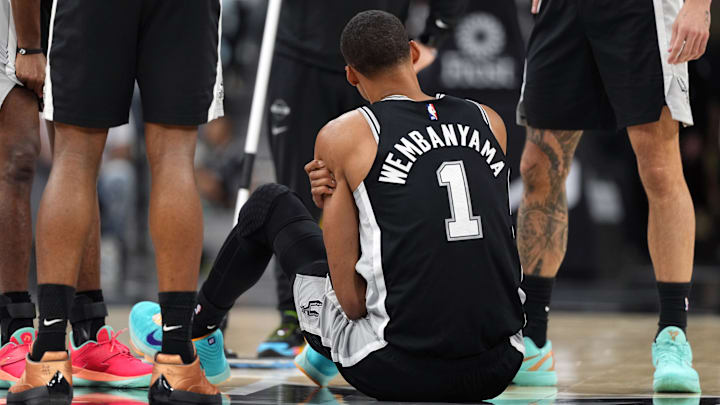 Apr 6, 2026; San Antonio, Texas, USA; San Antonio Spurs forward Victor Wembanyama (1) grabs his left shoulder during the first half against the Philadelphia 76ers at Frost Bank Center. Mandatory Credit: Scott Wachter-Imagn Images