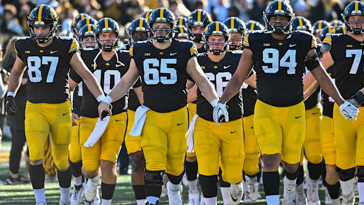 Nov 18, 2023; Iowa City, Iowa, USA; Iowa Hawkeyes tight end Addison Ostrenga (87) and quarterback Deacon Hill (10) and offensive lineman Logan Jones (65) and defensive lineman Yahya Black (94) come onto the field during the Iowa Swarm before the game against the Illinois Fighting Illini at Kinnick Stadium. Mandatory Credit: Jeffrey Becker-USA TODAY Sports