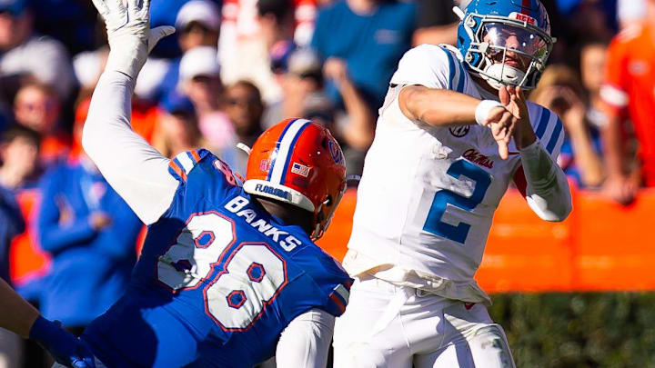 Mississippi Rebels quarterback Jaxson Dart (2) passes under pressure from Florida Gators defensive lineman Caleb Banks (88) during the second half at Ben Hill Griffin Stadium in Gainesville, FL on Saturday, November 23, 2024. The Gators defeated the Rebels 24-17 [Doug Engle/Gainesville Sun]