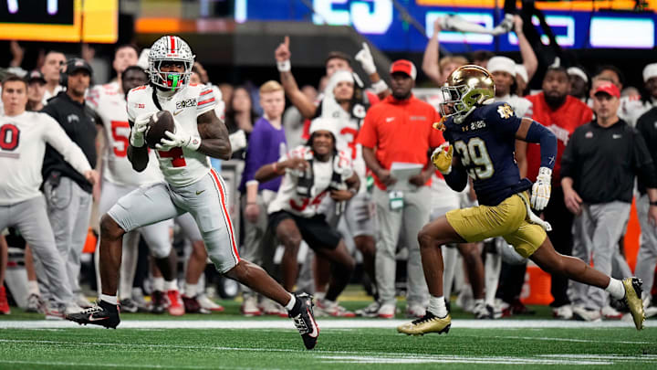 Ohio State Buckeyes wide receiver Jeremiah Smith (4) makes a catch against Notre Dame Fighting Irish cornerback Christian Gray (29) in the fourth quarter during the College Football Playoff National Championship at Mercedes-Benz Stadium in Atlanta on January 20, 2025.