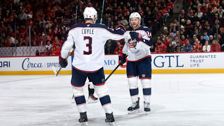 Blue Jackets center Charlie Coyle celebrates a goal with linemate Mathieu Olivier.