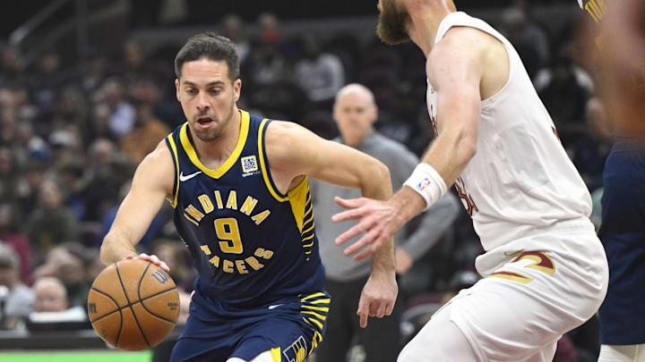 Oct 10, 2024; Cleveland, Ohio, USA; Indiana Pacers guard T.J. McConnell (9) dribbles beside Cleveland Cavaliers forward Dean Wade (32) in the first quarter at Rocket Mortgage FieldHouse. Mandatory Credit: David Richard-Imagn Images